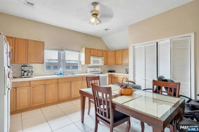 a bedroom with a bed and a flat tv screen on dresser