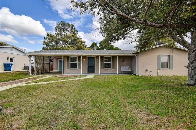 a view of a front door and small yard