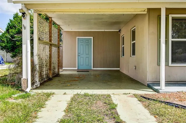 a backyard of a house with trees and wooden fence