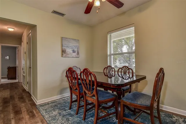 a view of a dining room with furniture and chandelier