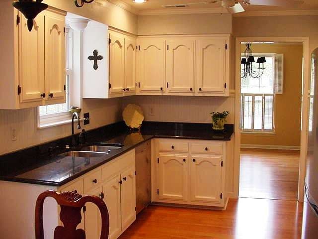 a kitchen with a refrigerator a sink and cabinets