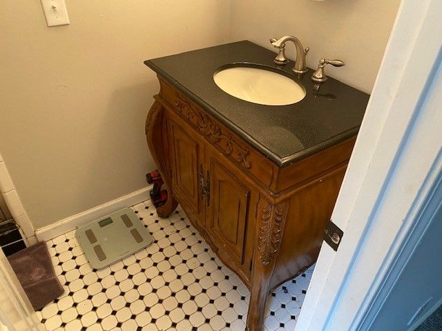 a bathroom with a sink a toilet and a mirror