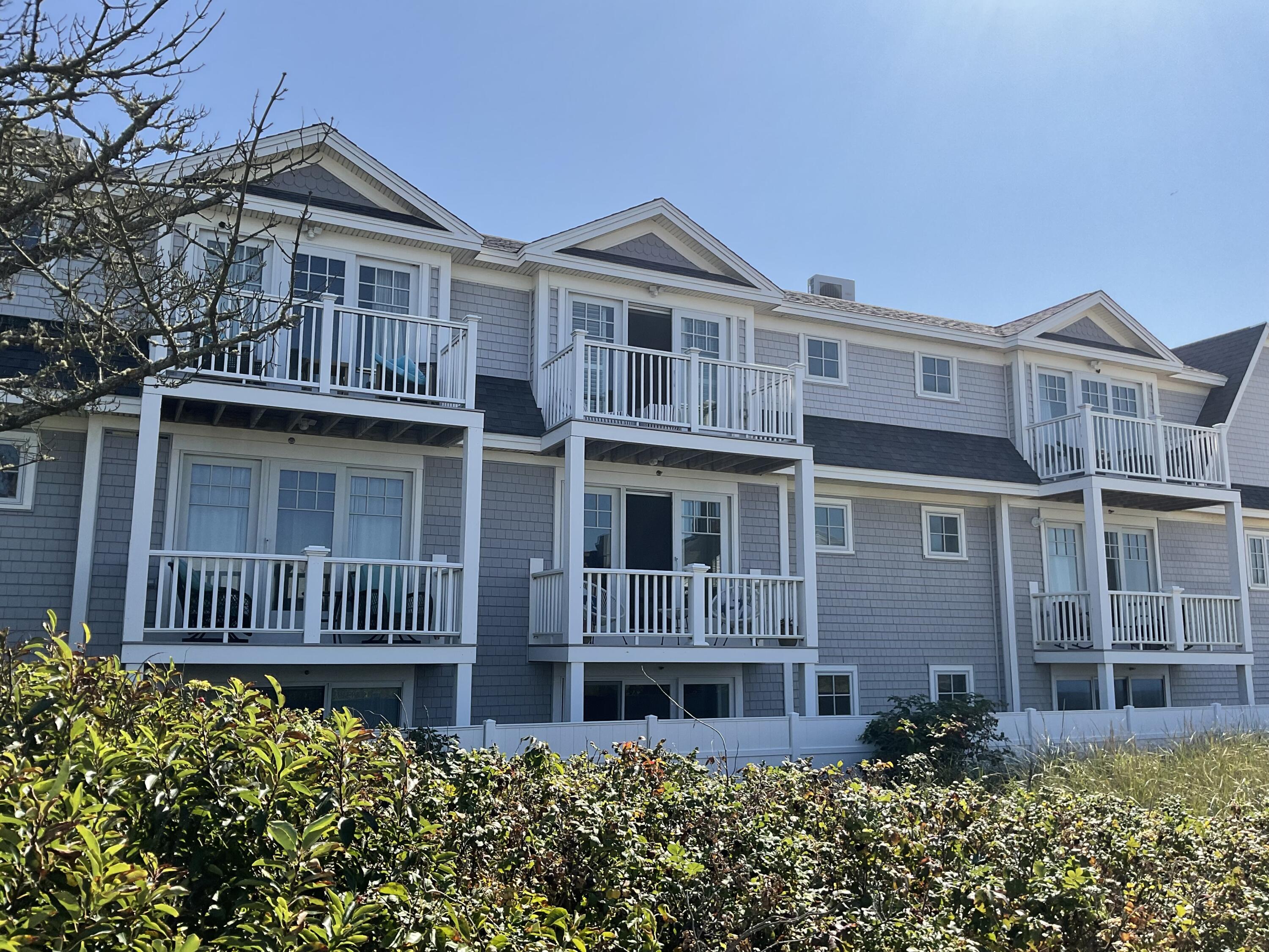 9 Chase Avenue, Unit U6 Dennis Port, MA 02639 - Photo 41 of 45 a front view of a house with a yard