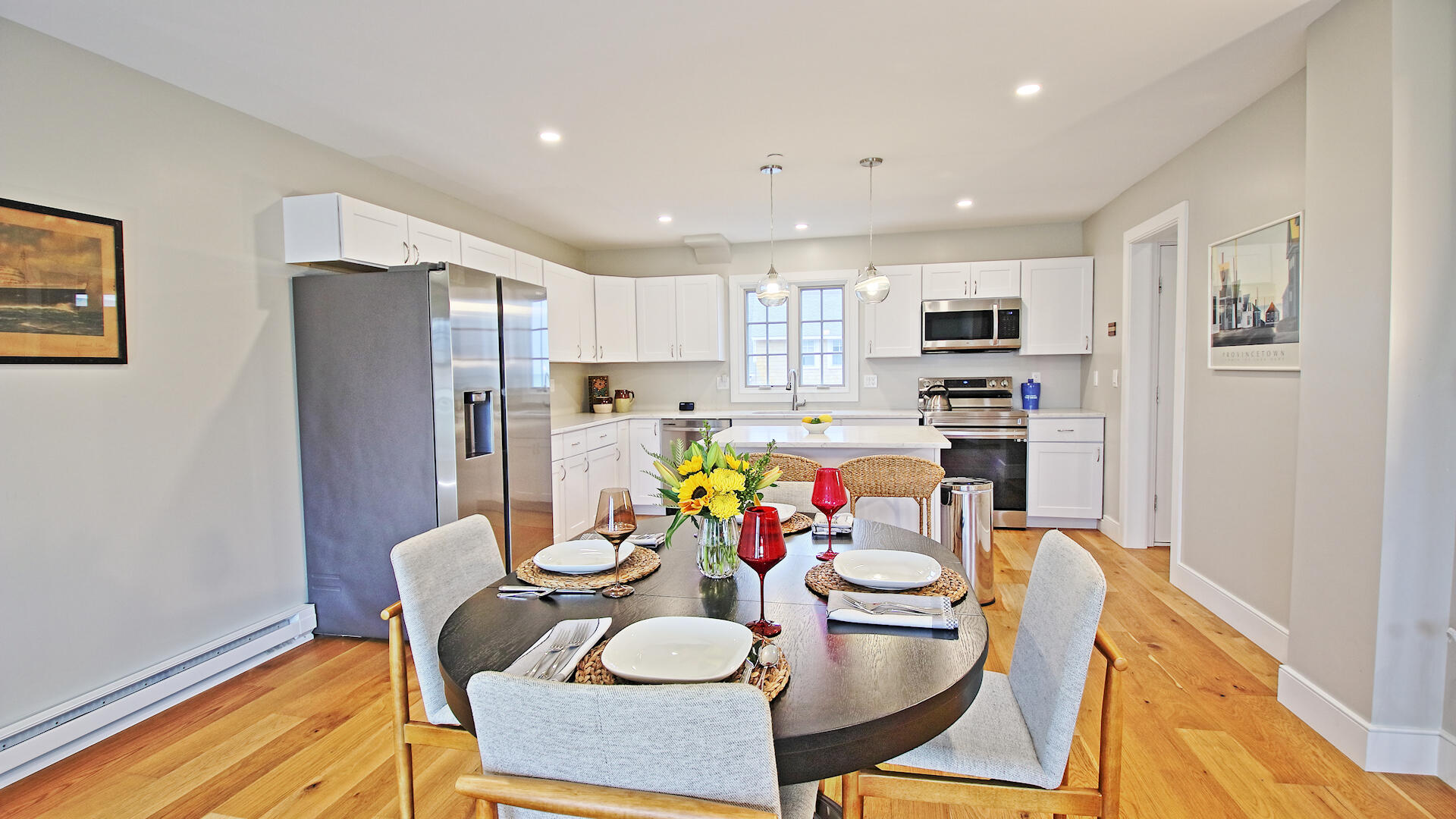 9 Chase Avenue, Unit U6 Dennis Port, MA 02639 - Photo 10 of 45 a kitchen with stainless steel appliances kitchen island granite countertop a dining table chairs and a refrigerator