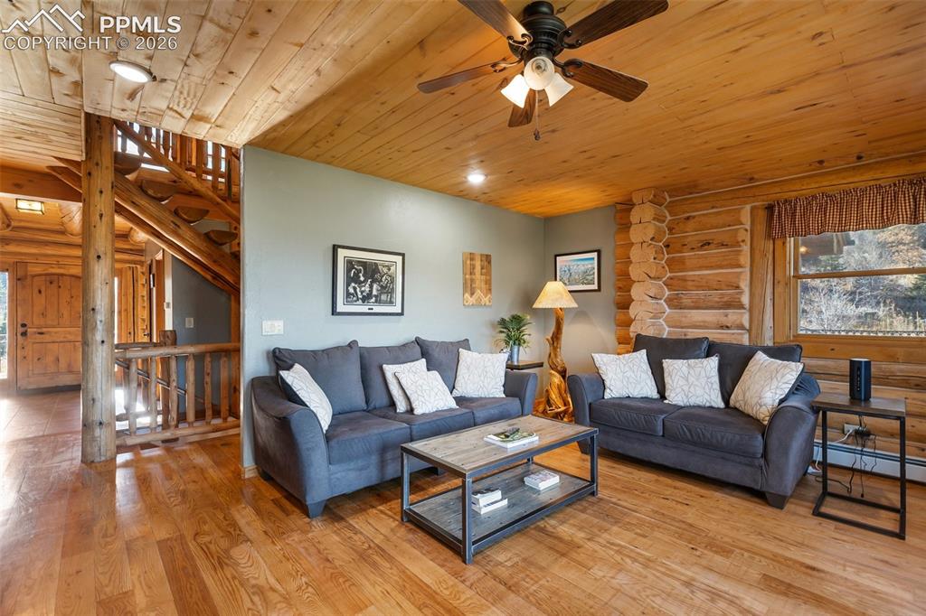 9110 Mountain Road Cascade, CO 80809 - Photo 6 of 49 a living room with furniture and a large window