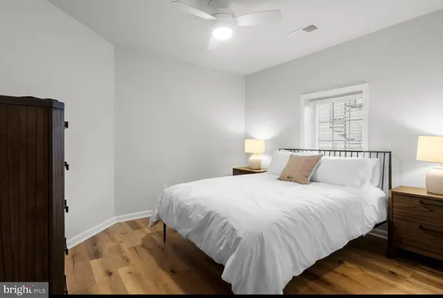 a bedroom with a bed and a night stand