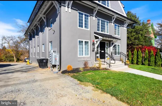 a view of a house with many windows and plants