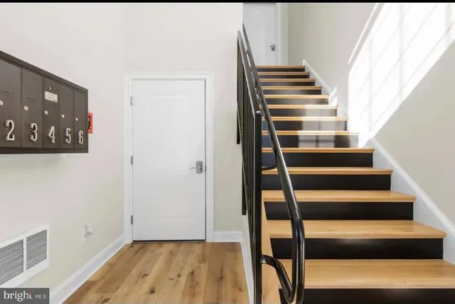 a view of entryway with wooden floor and stairs