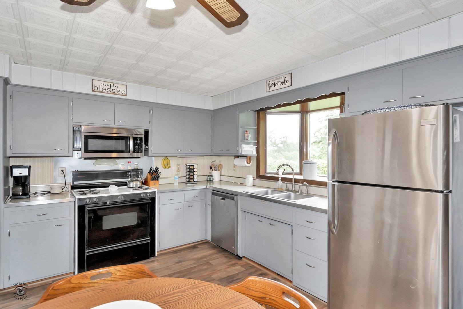 2780 North Cedar Road New Lenox, IL 60451 - Photo 7 of 25 a kitchen with a sink a white cabinets and stainless steel appliances