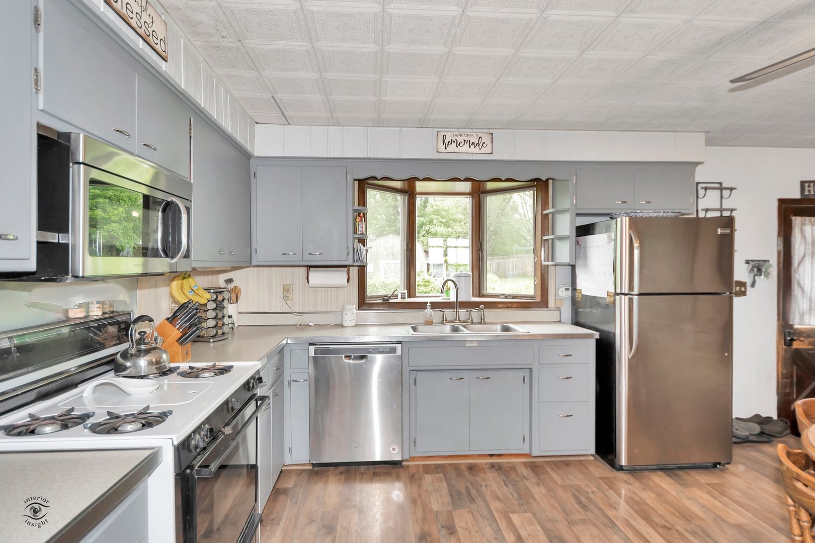 2780 North Cedar Road New Lenox, IL 60451 - Photo 8 of 25 a kitchen with a sink a stove a refrigerator and white cabinets