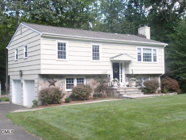 81 Ashbee Lane Ridgefield, CT 06877 - Photo 1 of 1 a front view of a house with garden