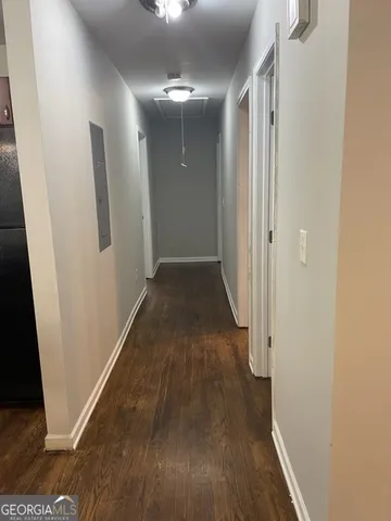 a view of a hallway with wooden floor
