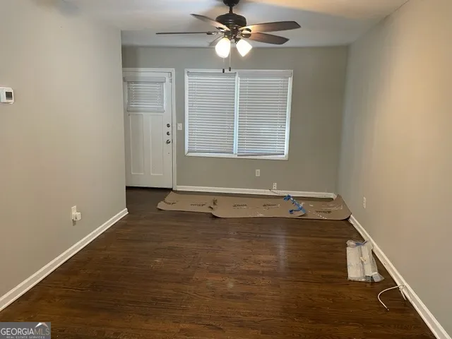 a view of room with window and ceiling fan