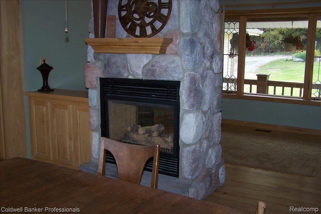 15501 Whitaker Road Linden, MI 48451 - Photo 6 of 22 FIREPLACE IN DINING ROOM