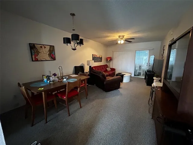 a living room with furniture a window and a flat screen tv