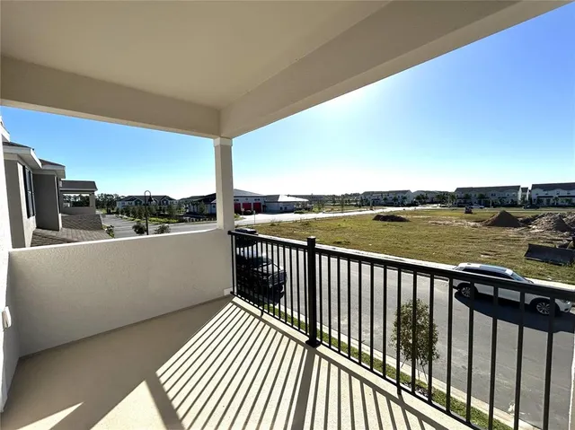 a view of a balcony with wooden floor and fence