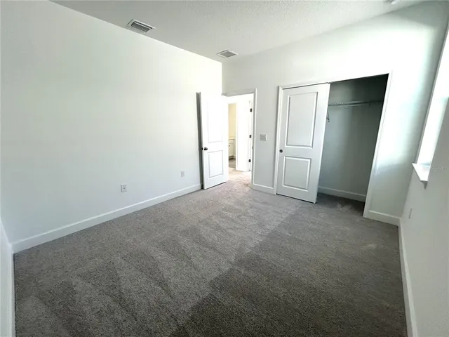 a spacious bathroom with a toilet sink and mirror