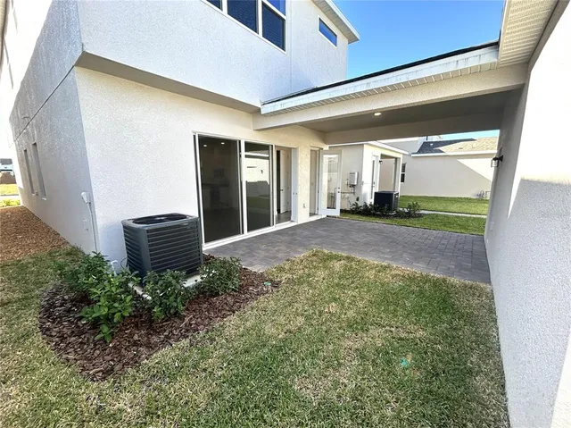 a view of a house with a backyard