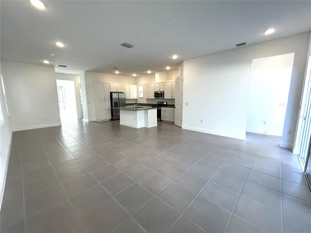 a view of a kitchen with a sink and cabinets