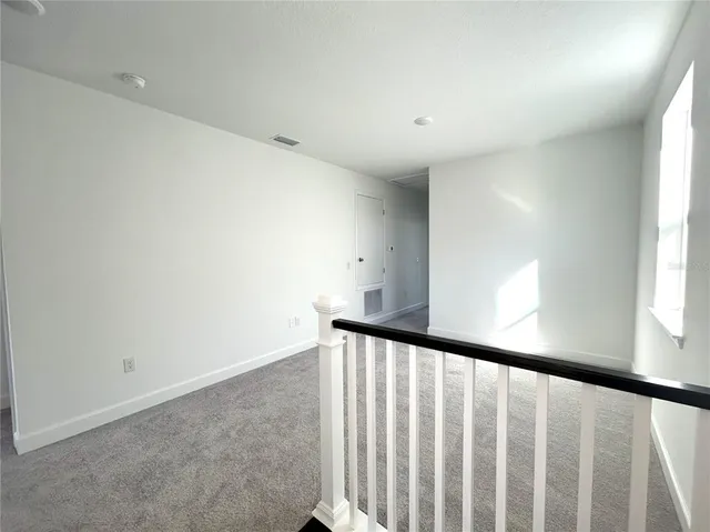 a view of staircase with rug floor