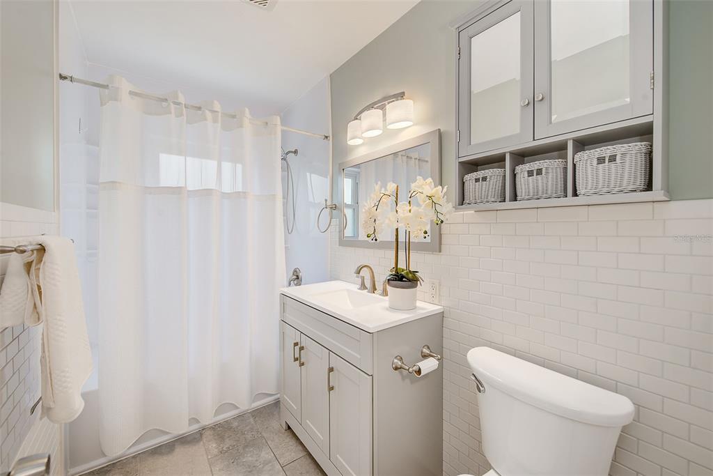 14079 Victoria Road Largo, FL 33774 - Photo 20 of 46 a bathroom with a granite countertop sink toilet and shower