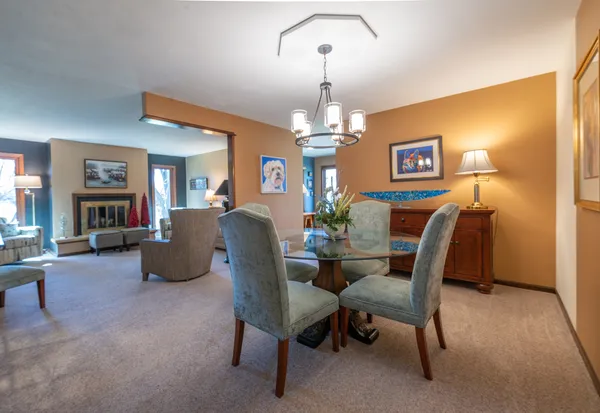 a view of a dining room with furniture and chandelier