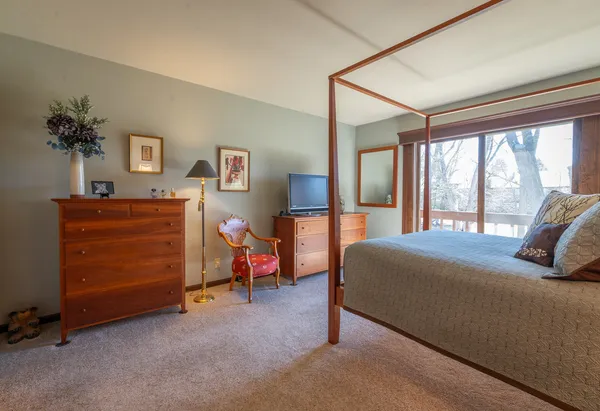 a bedroom with furniture and a flat screen tv