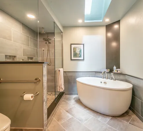 a bathroom with a granite countertop double vanity sink and a mirror