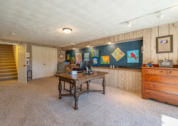 a dining room with furniture a chandelier and window