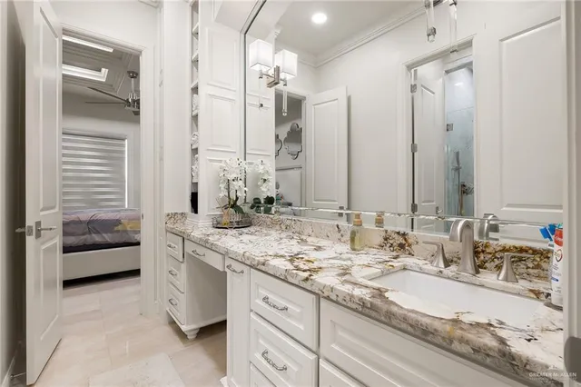 a bathroom with a granite countertop sink and a mirror