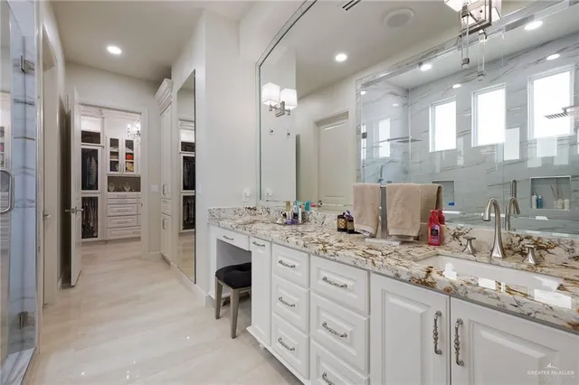 a bathroom with a sink double vanity and a shower