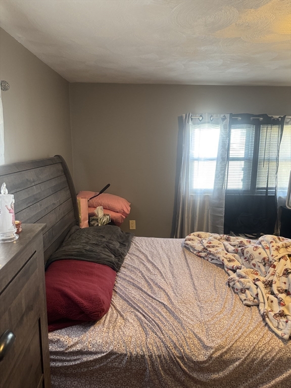 21 Cook, Unit 1 Chelsea, MA 02150 - Photo 11 of 32 a bedroom with a bed and a window
