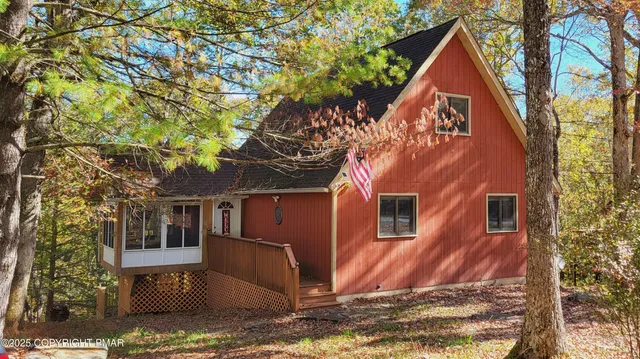 a view of a house with a tree front of house