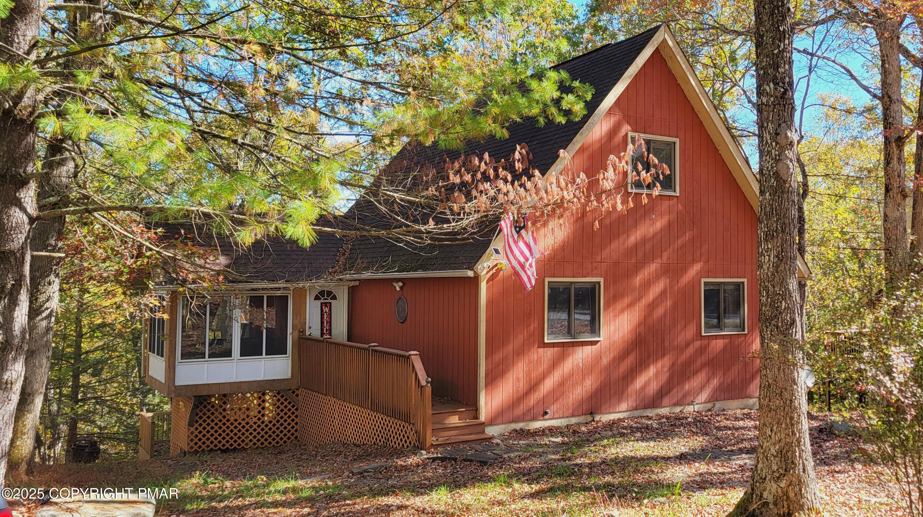 a view of a house with a tree front of house