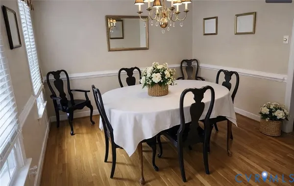a view of a dining room with furniture and wooden floor