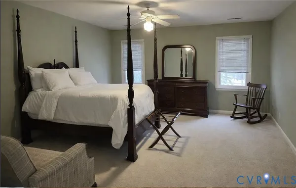 a bedroom with a bed a desk and chair