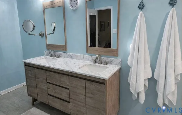 a bathroom with a sink vanity and a mirror
