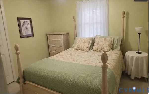 a bed sitting in a bedroom next to a window