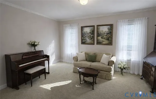 a living room with furniture and a piano
