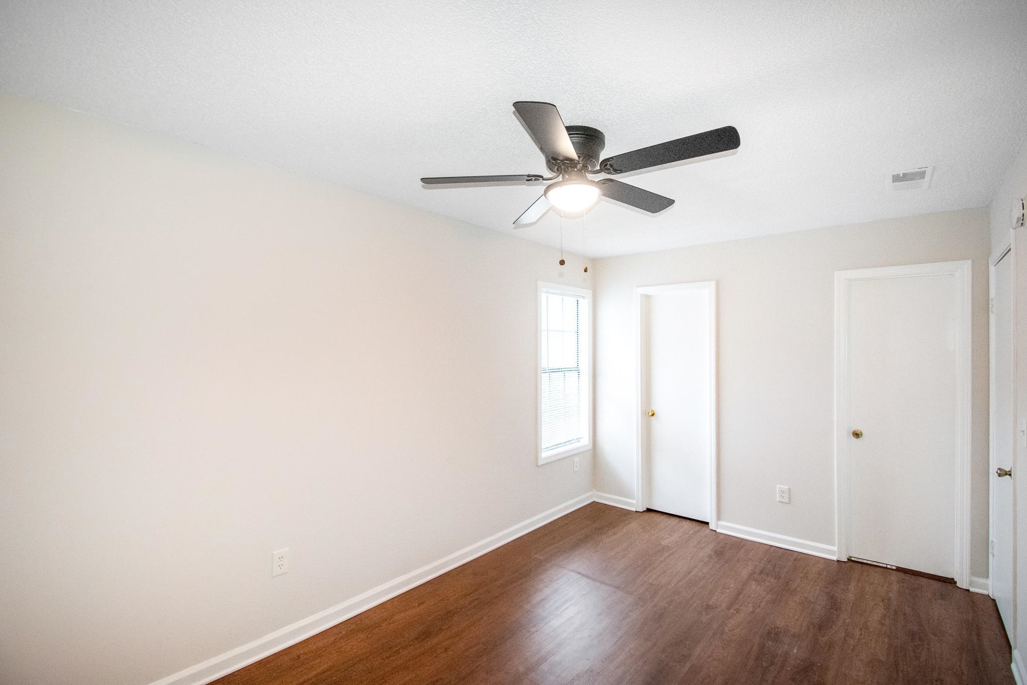 4775 Allrand Road Memphis, TN 38118 - Photo 13 of 21 an empty room with wooden floor and windows