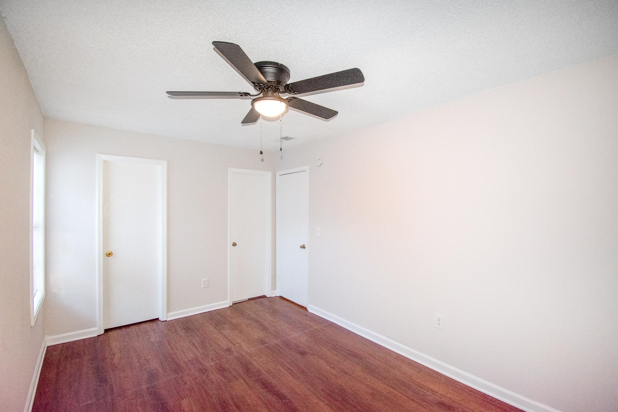 4775 Allrand Road Memphis, TN 38118 - Photo 14 of 21 a view of a big room with wooden floor and windows