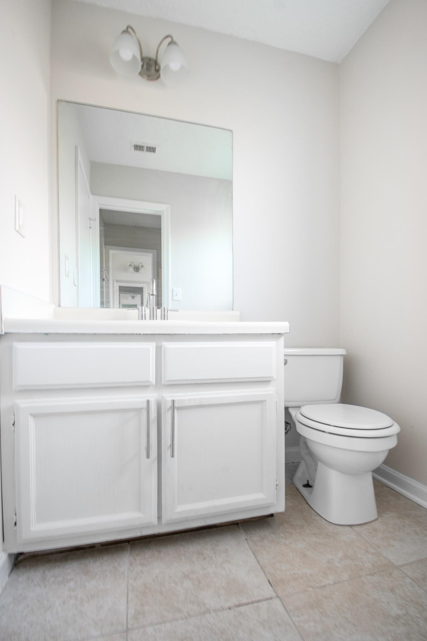 4775 Allrand Road Memphis, TN 38118 - Photo 19 of 21 a bathroom with a toilet sink and mirror
