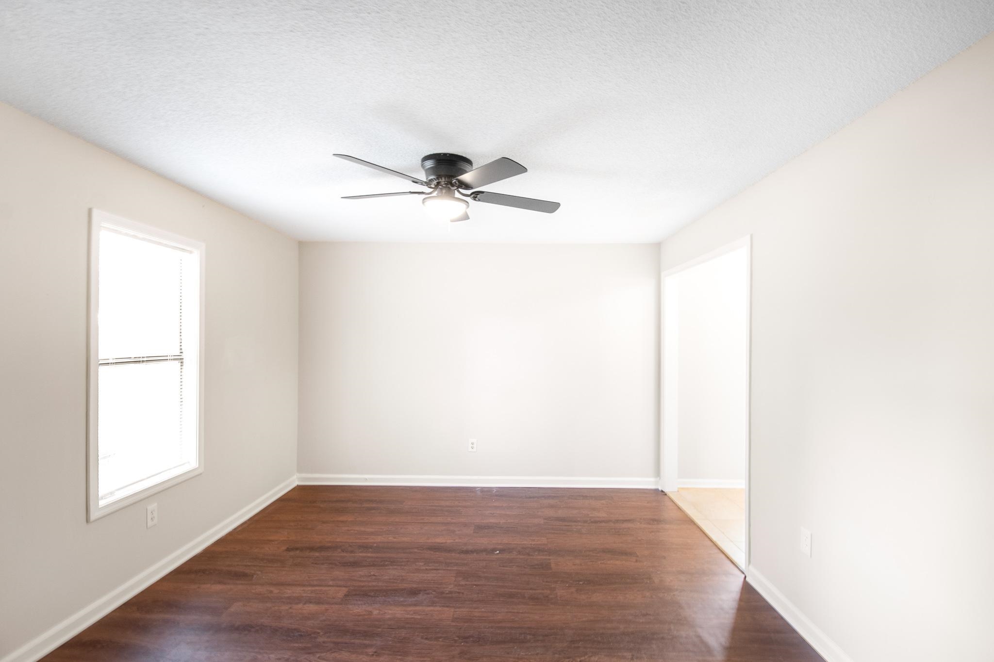 4775 Allrand Road Memphis, TN 38118 - Photo 21 of 21 a view of room with a ceiling fan and wooden floor