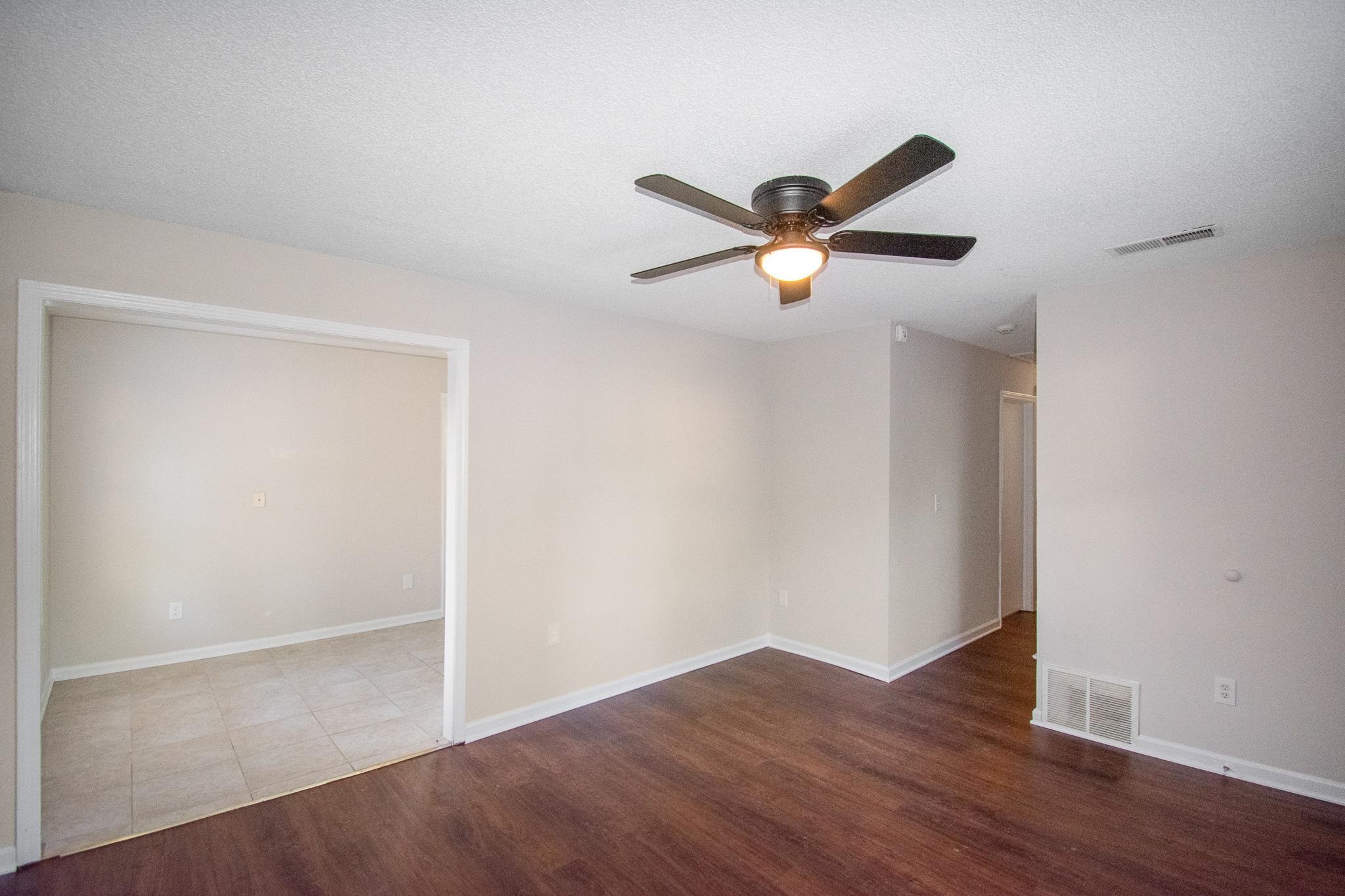 4775 Allrand Road Memphis, TN 38118 - Photo 5 of 21 an empty room with wooden floor and a ceiling fan
