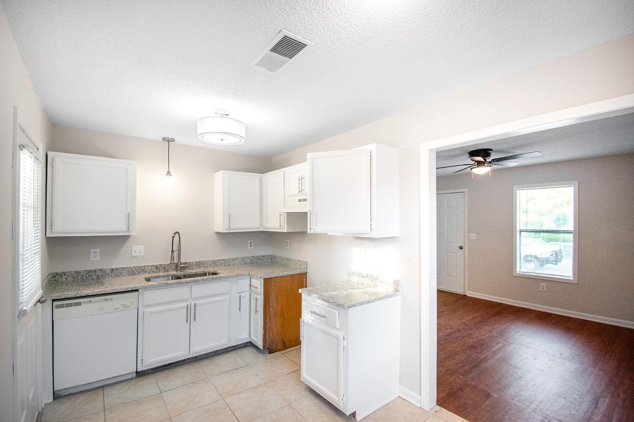4775 Allrand Road Memphis, TN 38118 - Photo 7 of 21 a kitchen with a refrigerator sink and cabinets