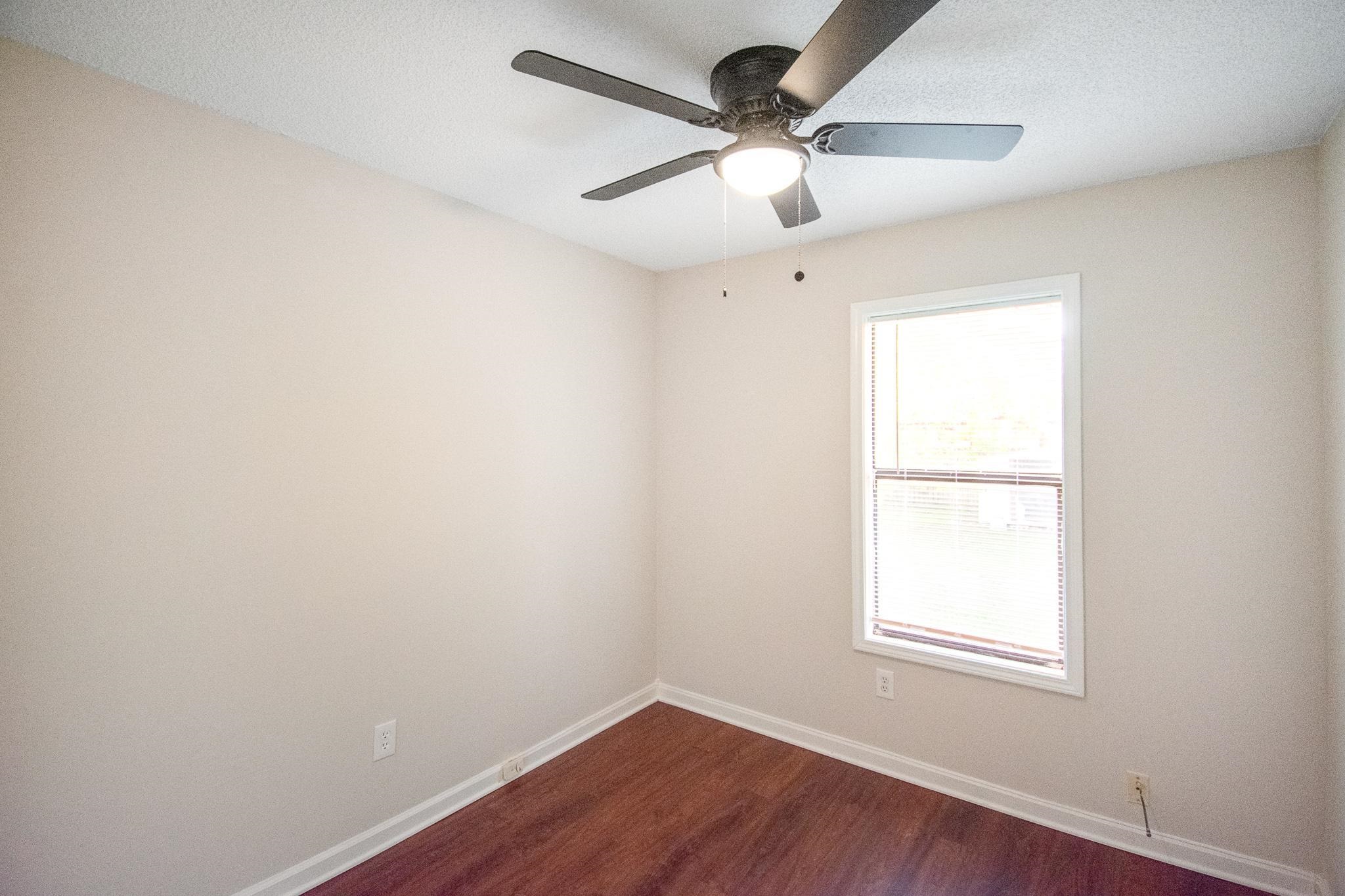 4775 Allrand Road Memphis, TN 38118 - Photo 10 of 21 an empty room with a window and a fan
