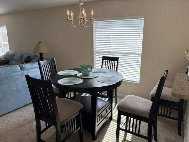 a view of a dining room with furniture and window