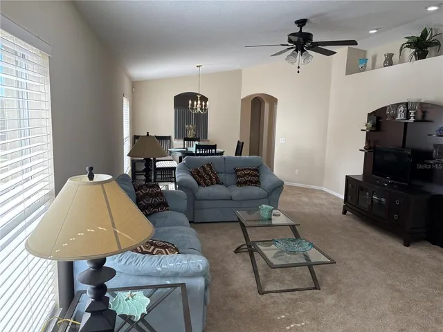 a living room with furniture and a mirror