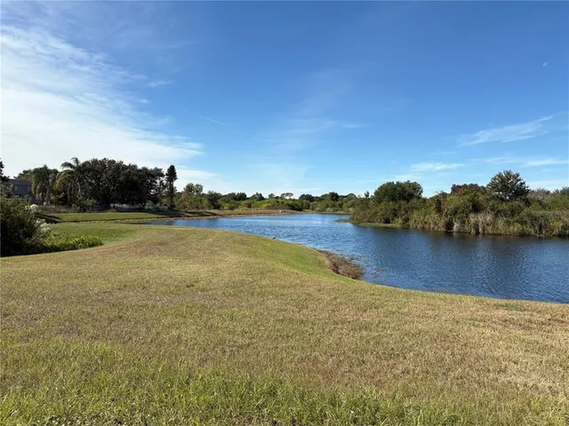 a view of a lake with houses in the back