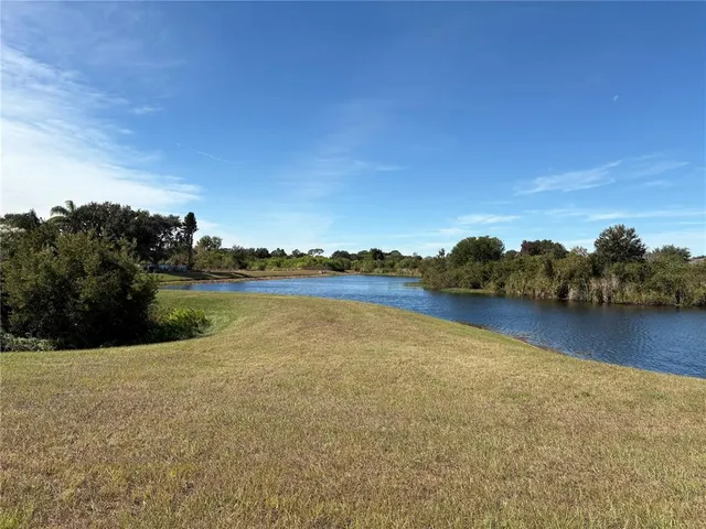 a view of a lake with houses in the background